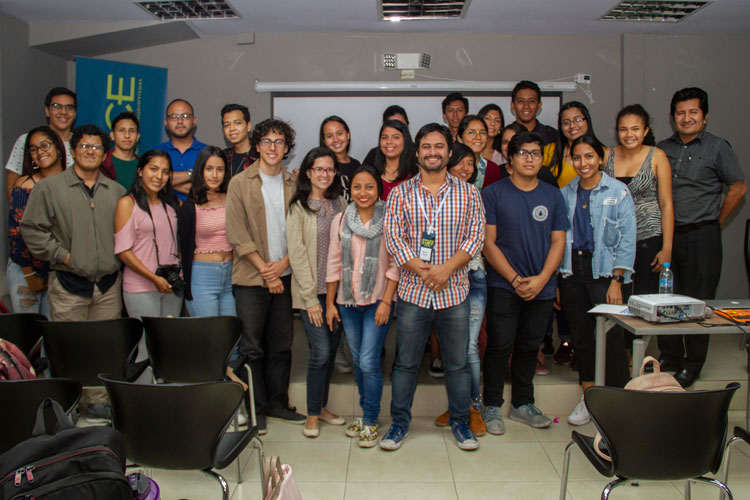 Alumnos posando para foto junto a expositor